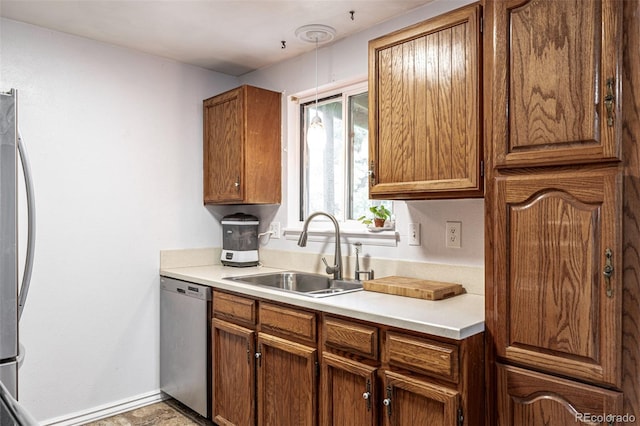 11886 Birch Dr, Thornton, CO 80233 - kitchen with appliances with stainless steel finishes, a sink, light countertops, brown cabinetry, and baseboards
