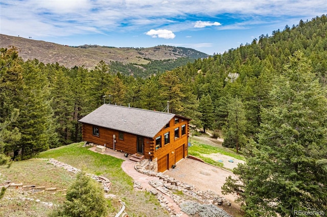 310 Wendelyn Way, Boulder, CO 80302 - view of subject property with a heavily wooded area and a mountainous background