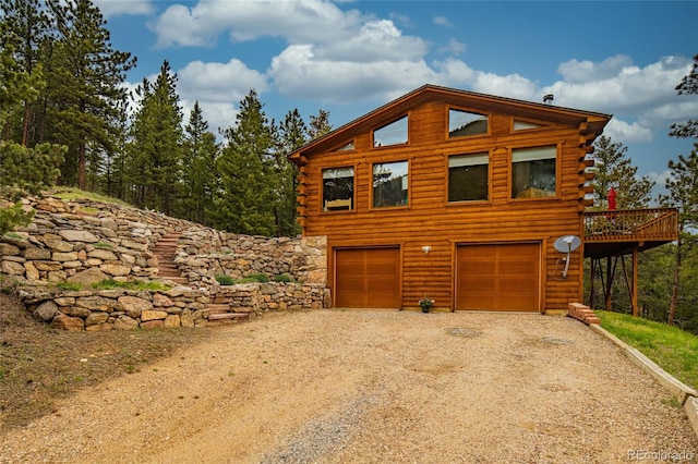 310 Wendelyn Way, Boulder, CO 80302 - view of front of property featuring driveway, a garage, log exterior, and a wooden deck