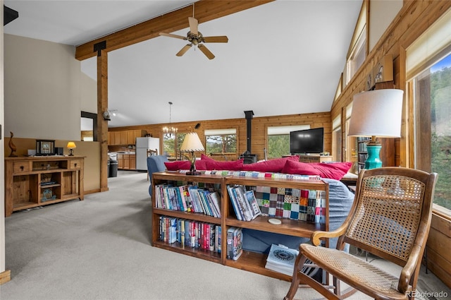 310 Wendelyn Way, Boulder, CO 80302 - sitting room featuring a wood stove, plenty of natural light, beamed ceiling, ceiling fan, and wood walls