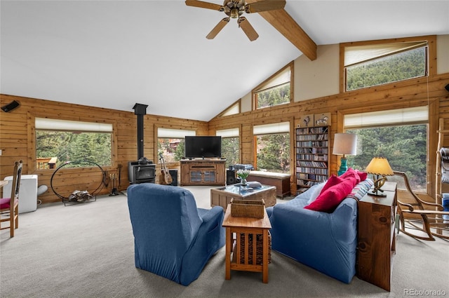 310 Wendelyn Way, Boulder, CO 80302 - living room with carpet floors, a wood stove, wood walls, healthy amount of natural light, and beam ceiling