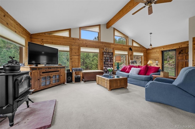 310 Wendelyn Way, Boulder, CO 80302 - carpeted living room featuring wooden walls, a wood stove, and a ceiling fan