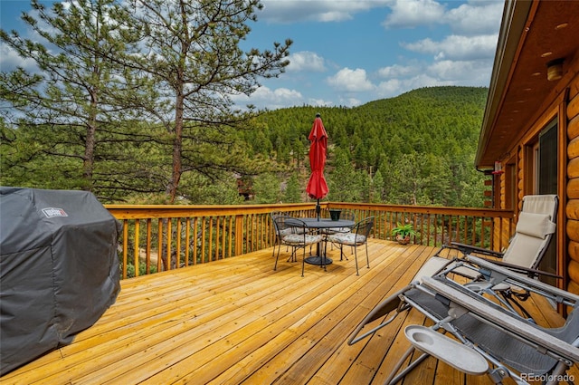 310 Wendelyn Way, Boulder, CO 80302 - wooden deck with a forest view, outdoor dining area, and a grill