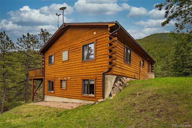 310 Wendelyn Way, Boulder, CO 80302 - rear view of property featuring log siding, a yard, a wooded view, and central AC