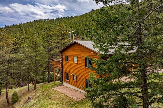 310 Wendelyn Way, Boulder, CO 80302 - view of property exterior featuring a view of trees, a balcony, and log exterior