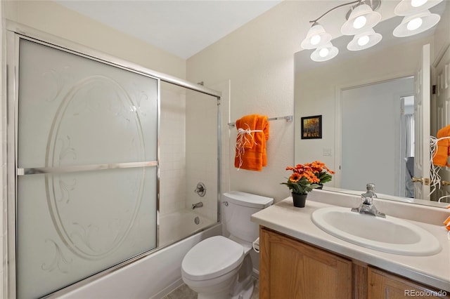 bathroom featuring a notable chandelier, shower / bath combination with glass door, vanity, and toilet