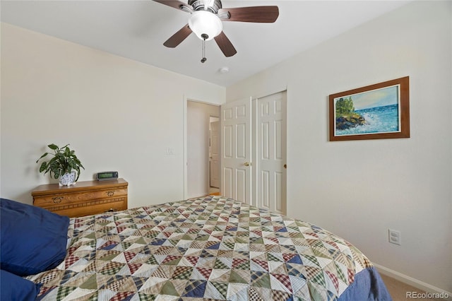 bedroom featuring a closet, a ceiling fan, and light colored carpet