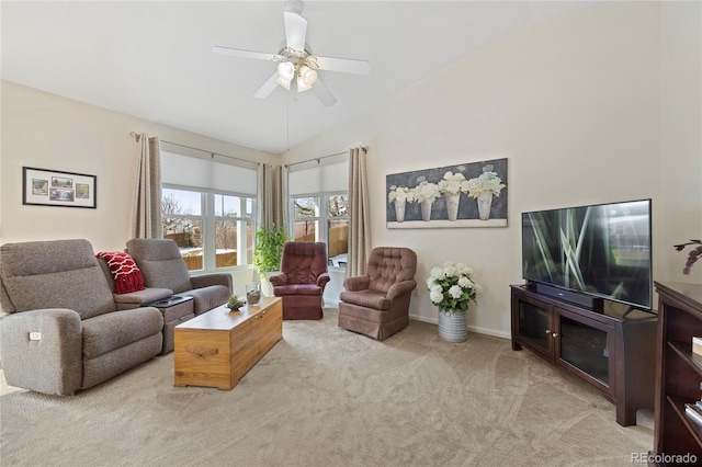 living area with a ceiling fan, lofted ceiling, light carpet, and baseboards