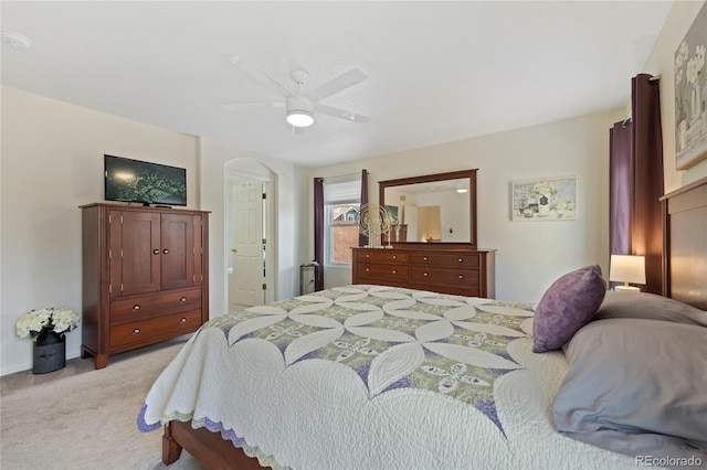 bedroom featuring light carpet and a ceiling fan