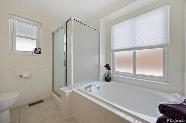 full bathroom with a wealth of natural light, a stall shower, and visible vents