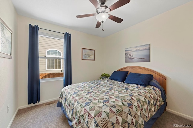 carpeted bedroom featuring baseboards, visible vents, and a ceiling fan