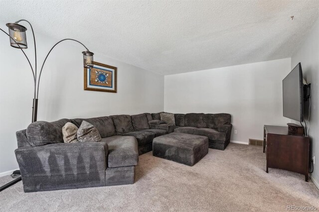 living room featuring light colored carpet, visible vents, a textured ceiling, and baseboards