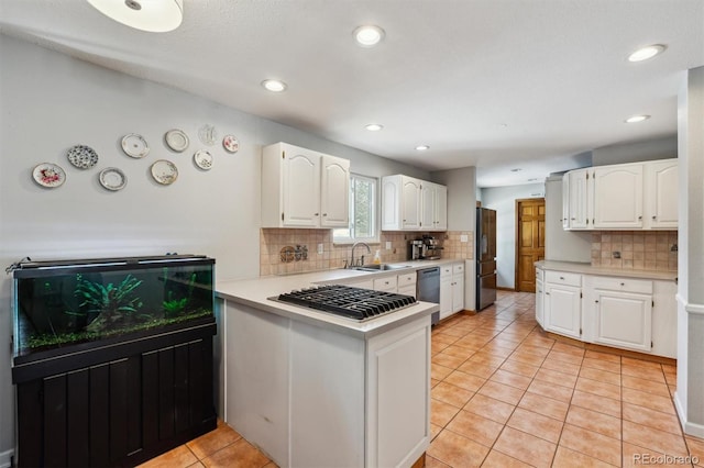 kitchen featuring light countertops, black appliances, and white cabinetry