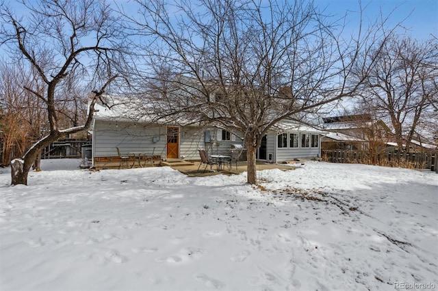 view of front of home with entry steps and a sunroom