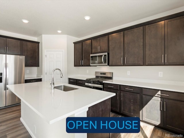 kitchen with dark wood-style flooring, dark brown cabinets, appliances with stainless steel finishes, and a sink