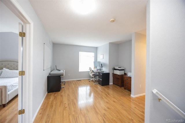 office space with light wood-style flooring and baseboards