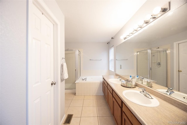 full bathroom featuring tile patterned flooring, a sink, and a shower stall
