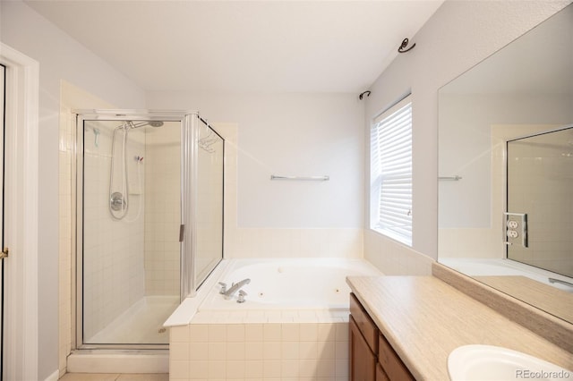 full bathroom featuring a jetted tub, vanity, and a stall shower