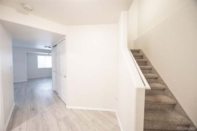 stairs with baseboards and wood finished floors