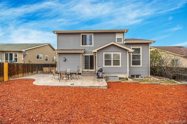 rear view of property featuring a fenced backyard, a patio area, and entry steps