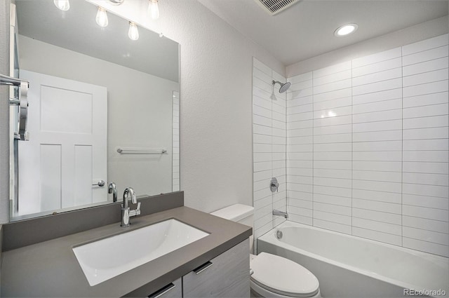 full bathroom featuring a textured wall, bathtub / shower combination, toilet, vanity, and visible vents