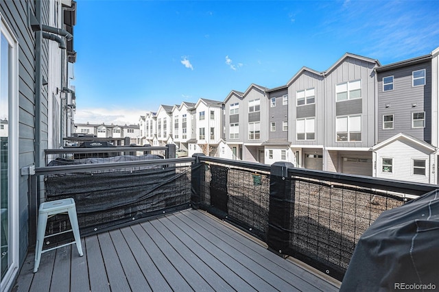 deck featuring a residential view and grilling area