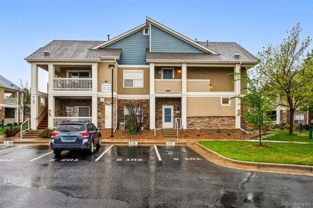 8200 E 8th Ave Unit 5-204, Denver, CO 80230 - view of building exterior featuring uncovered parking and stairs