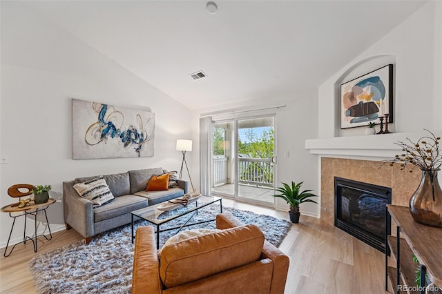 8200 E 8th Ave Unit 5-204, Denver, CO 80230 - living area with lofted ceiling, wood finished floors, a fireplace, and baseboards