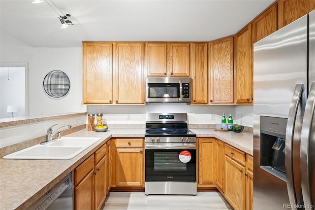 8200 E 8th Ave Unit 5-204, Denver, CO 80230 - kitchen with stainless steel appliances, a sink, light countertops, and a peninsula
