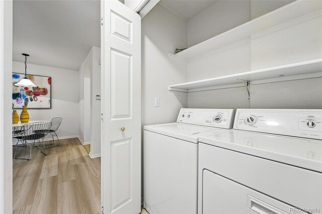 8200 E 8th Ave Unit 5-204, Denver, CO 80230 - washroom featuring light wood-style flooring, separate washer and dryer, and baseboards