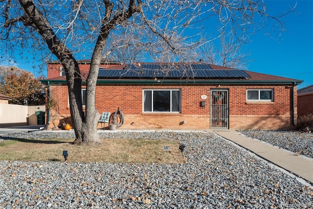 view of front facade with solar panels