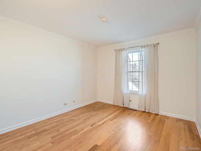 2301 E Fremont Ave Unit W03, Centennial, CO 80122 - empty room featuring ornamental molding, baseboards, light wood-style flooring, and a smoke detector
