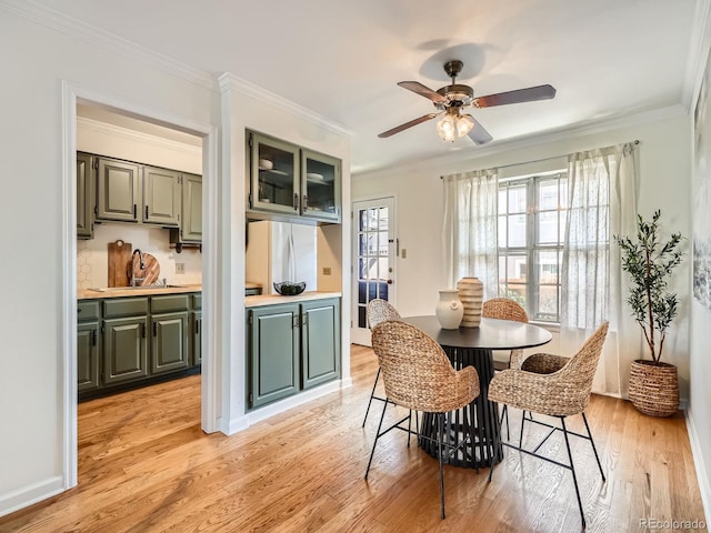 2301 E Fremont Ave Unit W03, Centennial, CO 80122 - dining area with light wood-type flooring, crown molding, and a ceiling fan