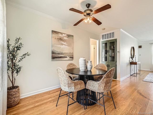 2301 E Fremont Ave Unit W03, Centennial, CO 80122 - dining room featuring light wood finished floors, ceiling fan, ornamental molding, and baseboards
