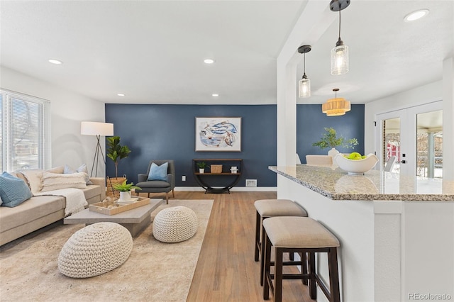 living room featuring light hardwood / wood-style floors and french doors