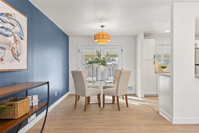 dining room with light wood-type flooring