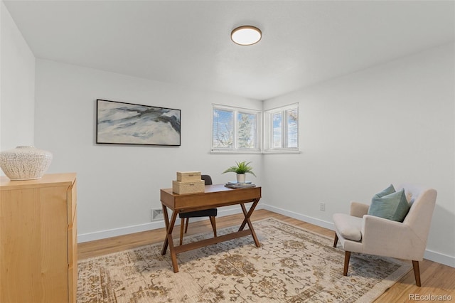 office area with light hardwood / wood-style floors