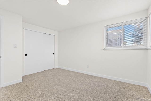 unfurnished bedroom with carpet and a closet