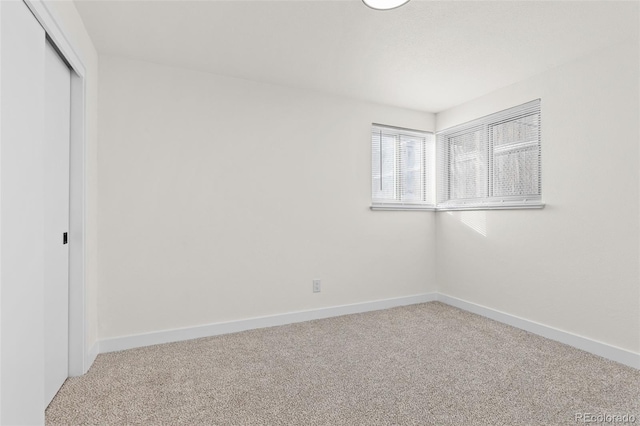 unfurnished bedroom featuring carpet floors and a closet