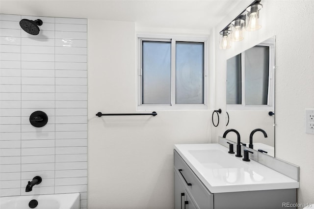 bathroom featuring vanity and tiled shower / bath combo