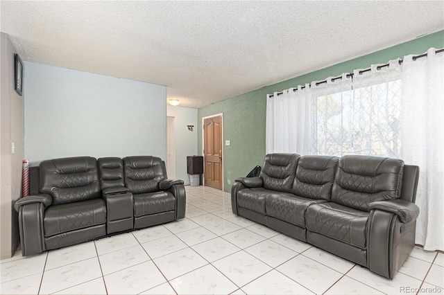 tiled living room featuring a textured ceiling