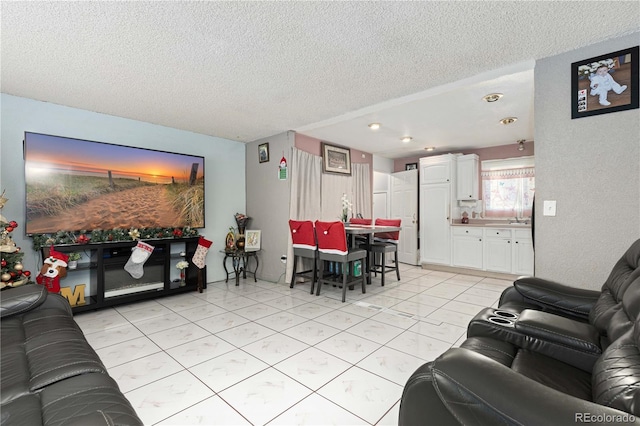 living room with sink and a textured ceiling