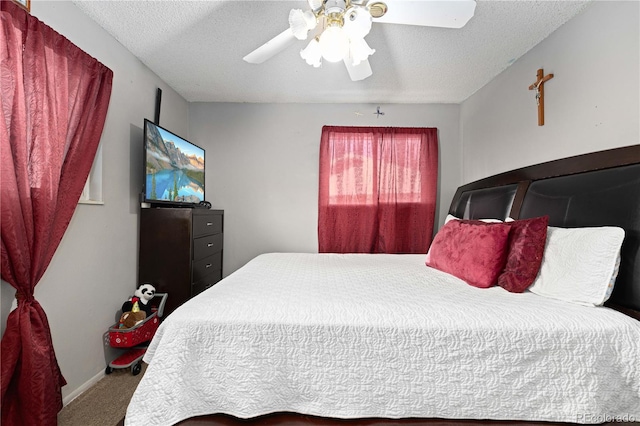 bedroom featuring ceiling fan, carpet floors, and a textured ceiling