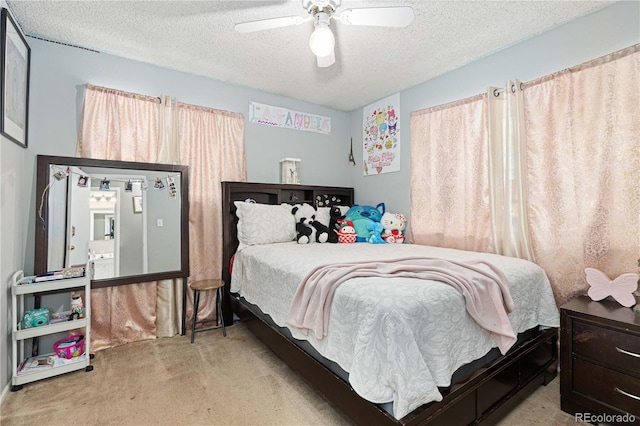 carpeted bedroom with a textured ceiling and ceiling fan