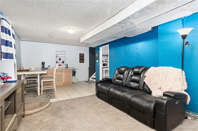 carpeted living room featuring a textured ceiling