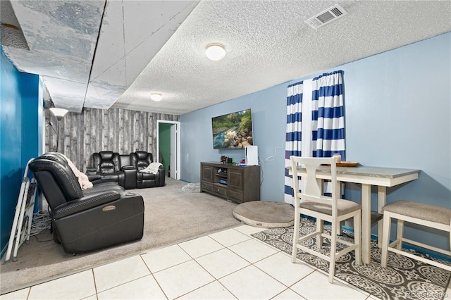 carpeted living room featuring a textured ceiling