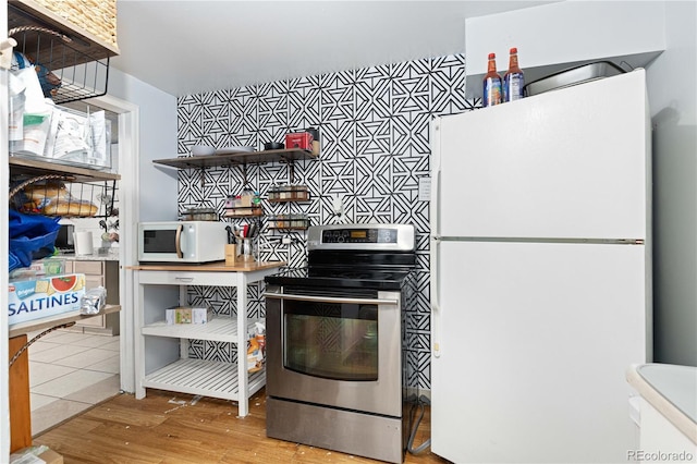 kitchen featuring light wood-type flooring and white appliances