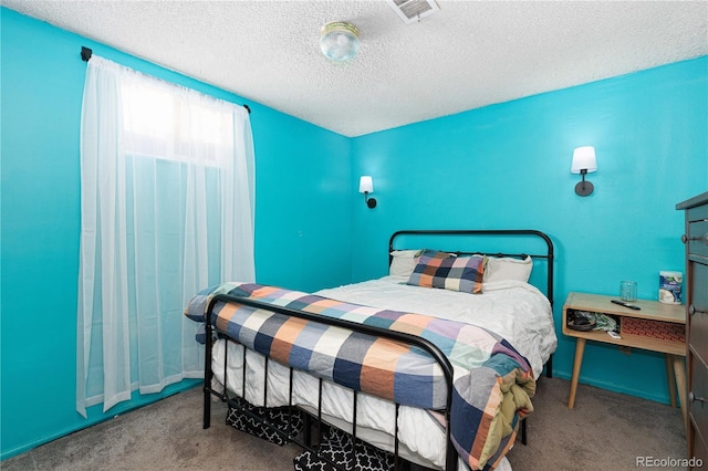 carpeted bedroom with a textured ceiling