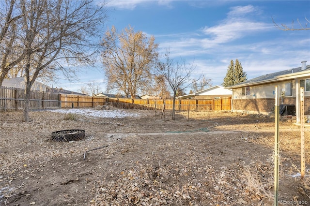 view of yard with an outdoor fire pit