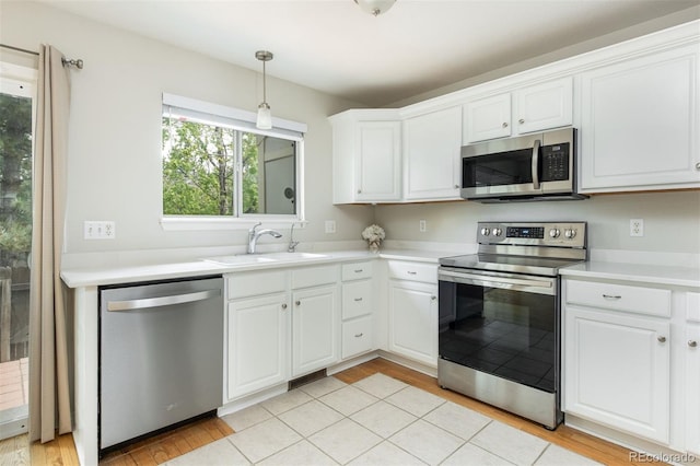 3098 W 107th Pl Unit C, Westminster, CO 80031 - kitchen with stainless steel appliances, a sink, light wood-style floors, white cabinets, and light countertops